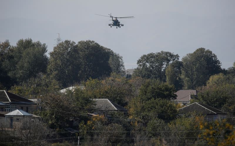 FILE PHOTO: An Azerbaijani military helicopter flies during the fighting over the breakaway region of Nagorno-Karabakh near the city of Terter