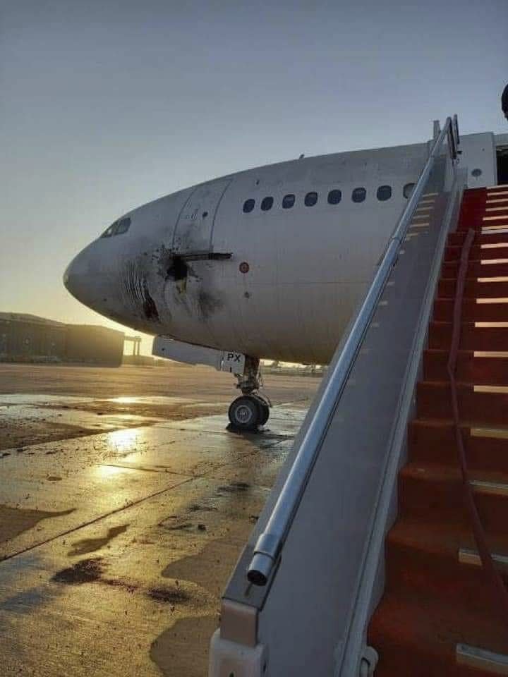 This photo from the media Office of the Ministry of Transport shows a damaged aircraft on the tarmac of Baghdad airport, after a rocket attack in Baghdad, Iraq, Friday, Jan. 28, 2022. At least three rockets struck near Baghdad's international airport and an adjacent military base that hosts U.S. and other coalition advisors on Friday, damaging an abandoned commercial plane but causing no casualties, Iraqi officials said. (The Ministry of Transport media Office via AP)