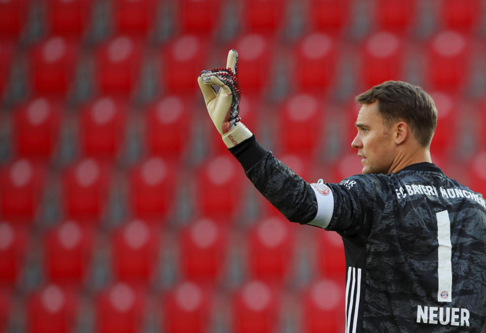 Munich's goal keeper Manuel Neuer gestures during the German Bundesliga soccer match between Union Berlin and Bayern Munich in Berlin, Germany, Sunday, May 17, 2020. The German Bundesliga becomes the world's first major soccer league to resume after a two-month suspension because of the coronavirus pandemic. (AP Photo/Hannibal Hanschke, Pool)