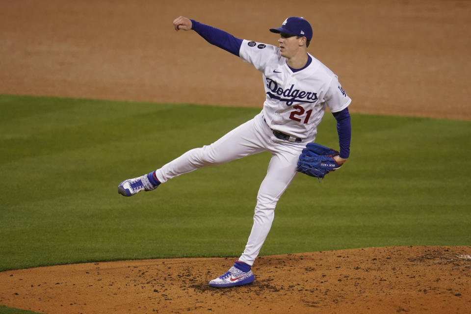 Los Angeles Dodgers starting pitcher Walker Buehler watches a throw to a San Diego Padres batter during the third inning of a baseball game Thursday, April 22, 2021, in Los Angeles. (AP Photo/Marcio Jose Sanchez)