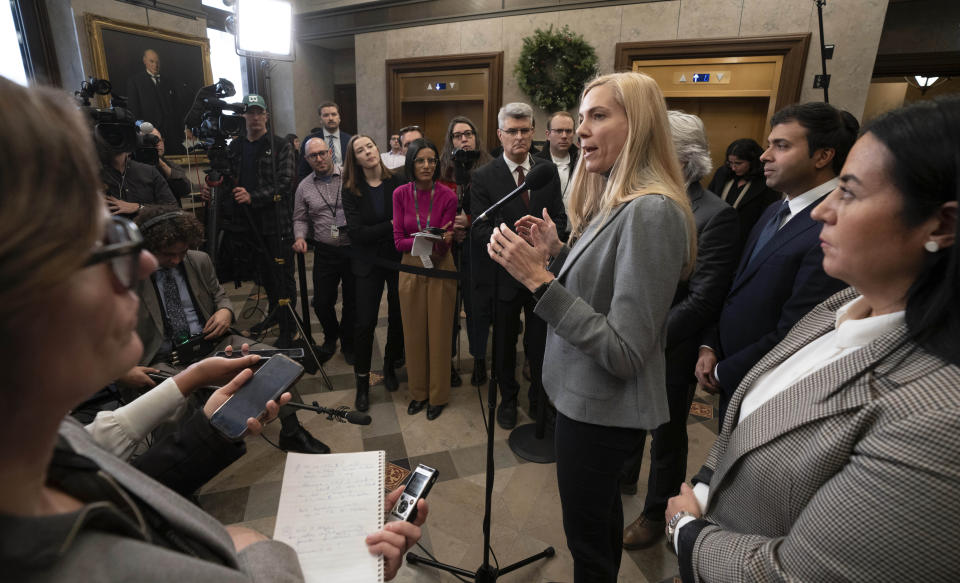 Members of Parliament and reporters listen as Canadian Heritage Minister Pascale St-Onge speaks about a deal with Google, Wednesday, Nov. 29, 2023, in the Foyer of the House of Commons in Ottawa, Ontario. Pascale St-Onge said that Google will contribute $100 million Canadian (US$74 million) — indexed to inflation — in financial support annually for a wide range of news businesses across the country. (Adrian Wyld/The Canadian Press via AP)