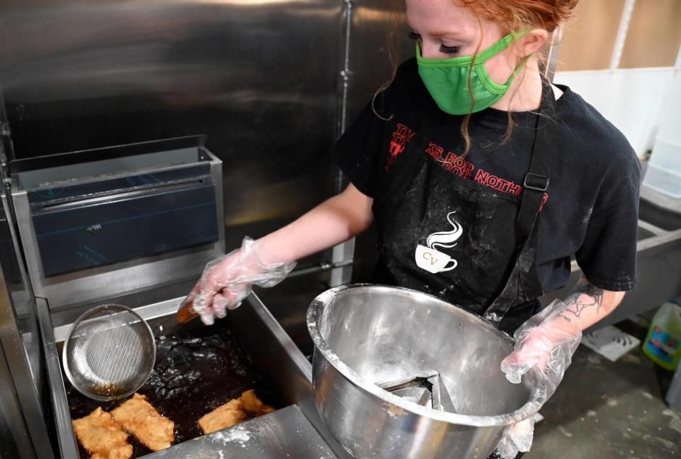 Morgan Barrientos, director of operations at Caffe Vignette in Warner Robins, turns an order of beignets in a fryer.