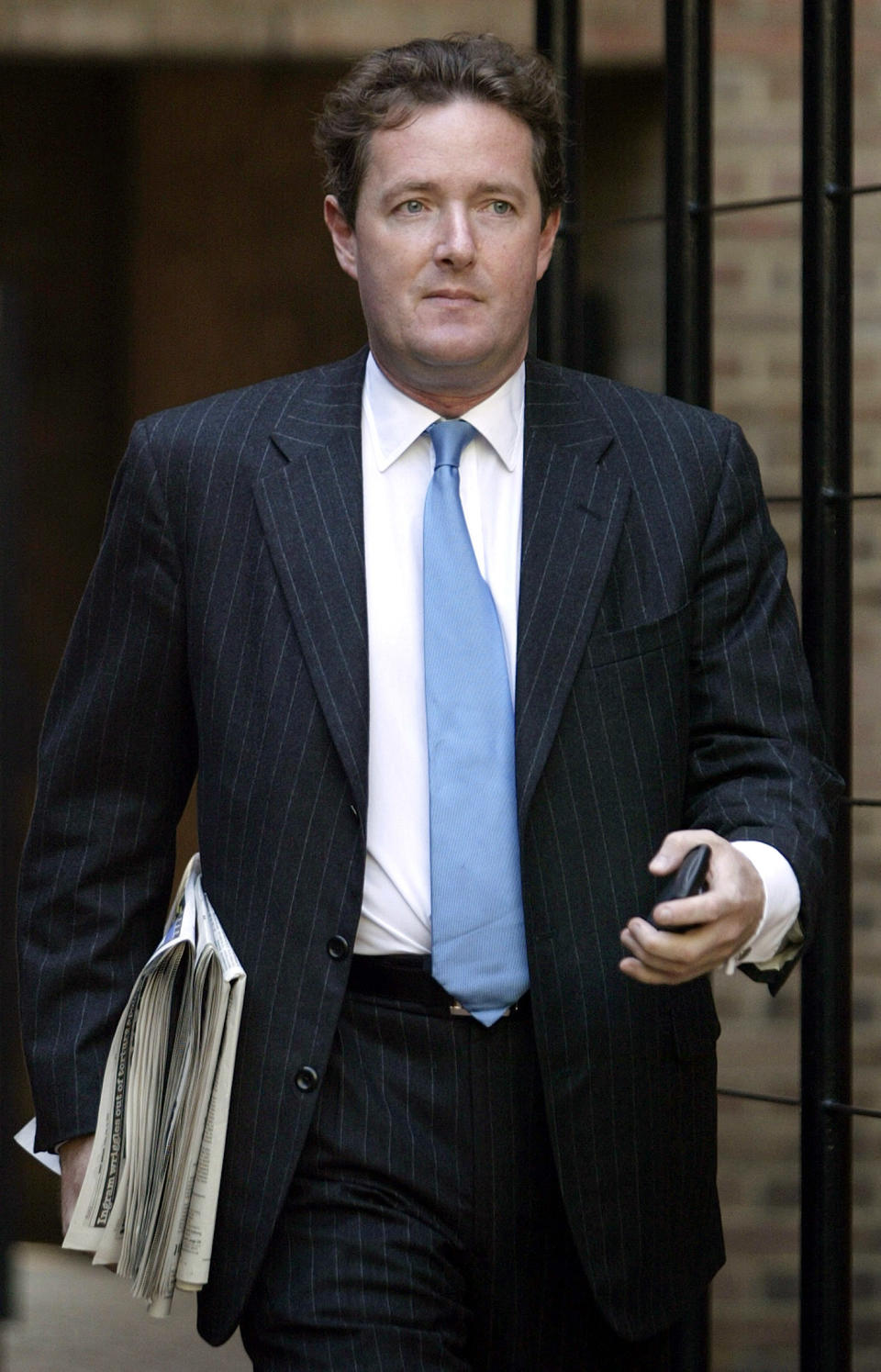 Editor of Britain's Daily Mirror newspaper Piers Morgan leaves his home in London, May 14, 2004. Morgan, editor of London's Daily Mirror newspaper, was ousted on Friday over publication of pictures of alleged abuse of Iraqi prisoners by British troops that proved to be fake. "The Board of Trinity Mirror has decided that it would be inappropriate for Piers Morgan to continue in his role as Editor  of the Daily Mirror and he will therefore be stepping down with immediate effect," the newspaper said in a statement.