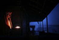 <p>A Hindu holy woman lights an oil lamp during the Maha Shivaratri festival in Kathmandu, Nepal, Friday, Feb. 24, 2017. Shivaratri, or the night of Shiva, is dedicated to the worship of Lord Shiva, the Hindu god of death and destruction.(AP Photo/Niranjan Shrestha) </p>