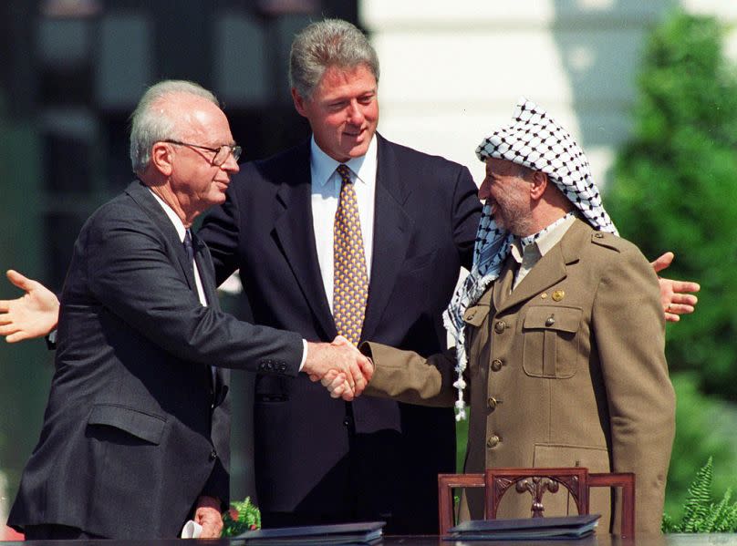 Israeli PM Yitzhak Rabin and Palestinian leader Yasser Arafat shake hands marking the signing of the peace accord in Washington, September 1993