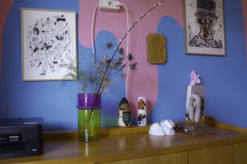 wood dining room sideboard with blue and pink painted wall behind