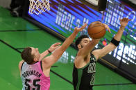Miami Heat's Duncan Robinson, left, drives toward the basket as Boston Celtics' Jayson Tatum, right, deflects the ball in the first half of a basketball game, Sunday, May 9, 2021, in Boston. (AP Photo/Steven Senne)
