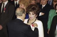 FILE - Italian movie star Gina Lollobrigida received the Legion of Honor from the hands of French President Francois Mitterrand during a ceremony at the Elysee Palace in Paris, Wednesday, Feb. 17, 1993. Lollobrigida has died in Rome at age 95. Italian news agency Lapresse reported Lollobrigida’s death on Monday, Jan. 16, 2023 quoting Tuscany Gov. Eugenio Giani. (AP Photo/Laurent Rebours, File)