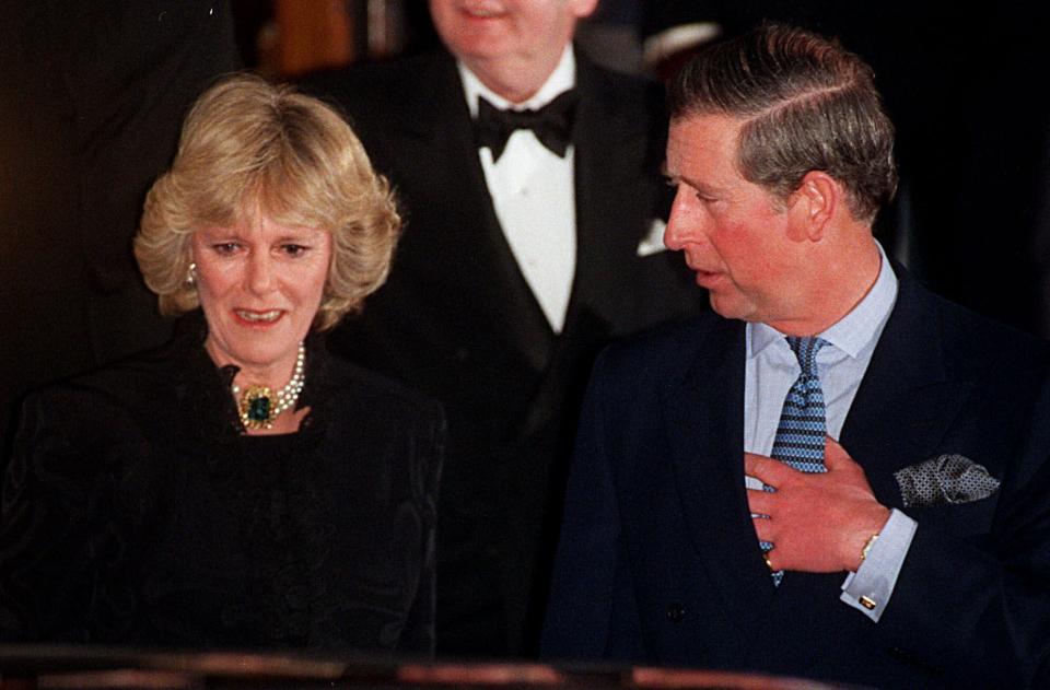 FILE - In this Thursday, Jan. 28, 1999 file photo, Britain's Prince Charles and his companion Camilla Parker Bowles leave the Ritz Hotel in London, the first time that the couple, who have been friends for more than 25 years, have appeared together in public. As Prince Charles turns 70 on Wednesday Nov. 14, 2018, Camilla says the public doesn’t understand how “incredibly kind” and funny Charles is. (AP Photo/Alastair Grant, File)