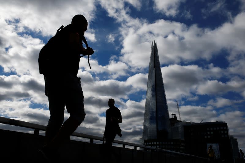 People walk over London Bridge, amid the coronavirus disease (COVID-19) outbreak, in London