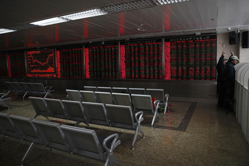 Investors check share prices at a quiet brokerage house in Beijing, Wednesday, March 27, 2019. Shares were mixed in Asia early Wednesday after U.S. stocks finished broadly higher on Wall Street, erasing modest losses from a day earlier. (AP Photo/Andy Wong)