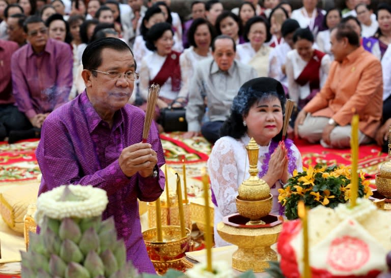 Cambodia's Prime Minister Hun Sen and his wife Bun Rany take part in a mass prayer ceremony at Angkor Wat temple in Siem Reap province to highlight the kingdom's continuing "peace, independence and political stability", on December 2, 2017 Secured by family and party ties, Chinese cash and his own ruthless political instincts, Cambodian strongman Hun Sen has taken a wrecking ball to the kingdom’s fragile democracy in a campaign to extend his 32-year rule