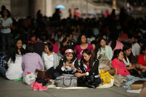 Foreign domestic helpers gather beneath the HSBC building in the Central district of Hong Kong. A court ruling has given them a chance to apply for permanent residency -- but the decision, which has polarised opinions in the southern Chinese city, has also prompted different reactions among maids themselves