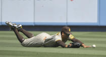 San Diego Padres center fielder Trent Grisham dives but cannot catch a fly ball hit by Los Angeles Dodgers' Trea Turner in the first inning during in a baseball game Sunday, Sept. 12, 2021, in Los Angeles, Calif. (AP Photo/John McCoy)