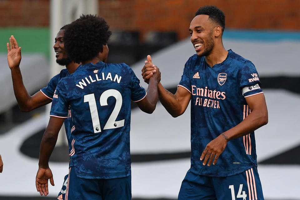 Pierre-Emerick Aubameyang (right) capped Arsenal's 3-0 rout of Fulham in Saturday's Premier League opener. (Ben Stansall/Getty Images)