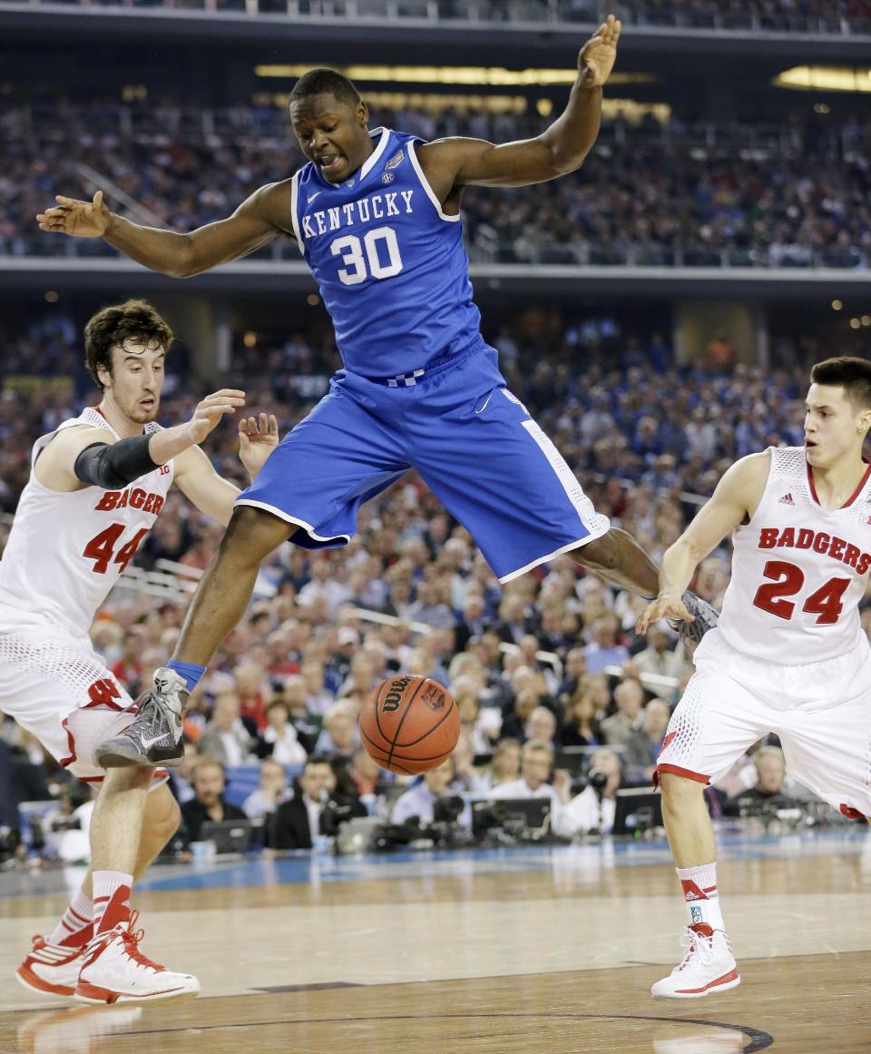 Kentucky forward Julius Randle (30) loses the ball as Wisconsin forward Frank Kaminsky (44) and guard Bronson Koenig (24) defend during the first half of the NCAA Final Four tournament college basketball semifinal game Saturday, April 5, 2014, in Arlington, Texas. (AP Photo/Eric Gay)