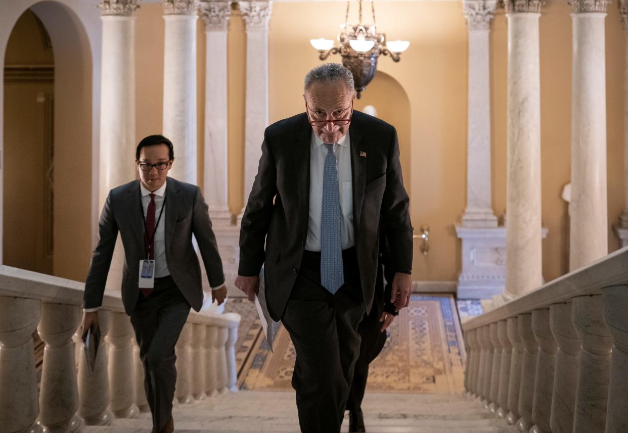 Senate Minority Leader Chuck Schumer, D-N.Y., takes the stairs to speak to reporters about progress in the impeachment trial of President Donald Trump on charges of abuse of power and obstruction of Congress, at the Capitol in Washington, Thursday, Jan. 23, 2020. (AP Photo/J. Scott Applewhite)
