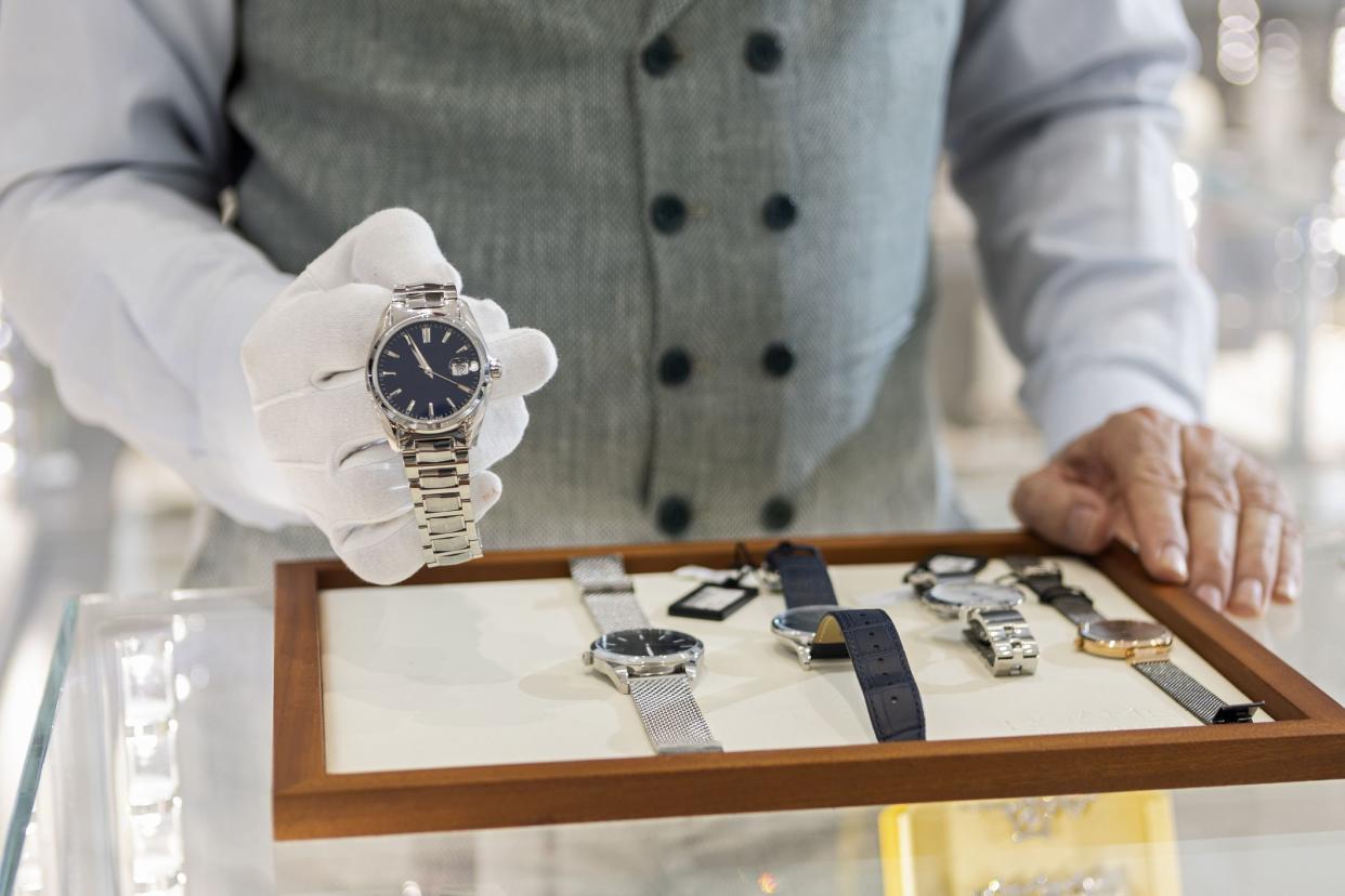 Senior man in jewelry store selling luxury watches