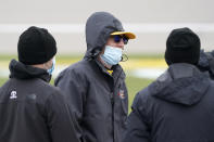 Kyle Busch tries to stay warm before a NASCAR Cup Series auto race at Kansas Speedway in Kansas City, Kan., Sunday, Oct. 18, 2020. (AP Photo/Orlin Wagner)