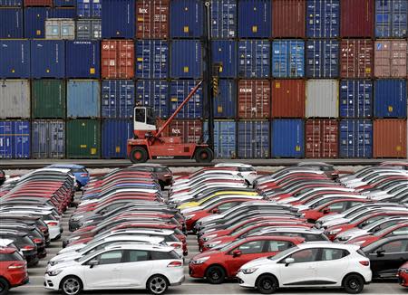 Renault cars produced in Turkey and awaiting export throughout Europe, are lined-up in front of ship containers in the port of Koper October 14, 2013. REUTERS/Srdjan Zivulovic