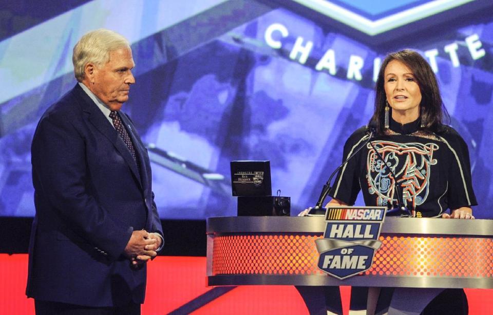 Lynda Hendrick, wife of NASCAR Hall of Fame inductee Rick Hendrick, left, introduces her husband during the NASCAR Hall of Fame induction ceremony in Charlotte, N.C., Friday, Jan. 20, 2017. (AP Photo/Mike McCarn)