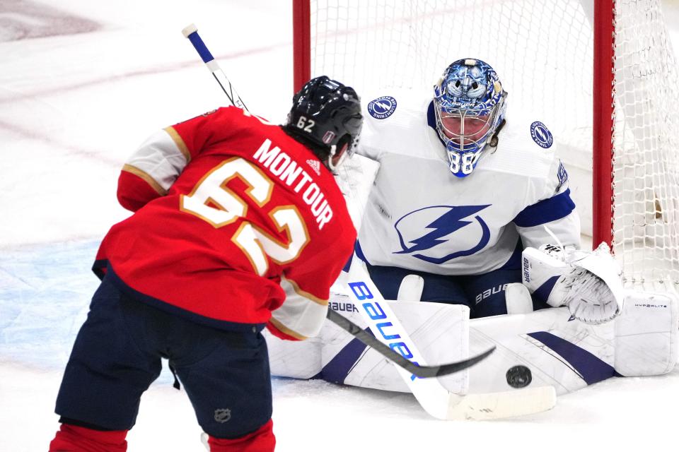 Apr 29, 2024; Sunrise, Florida, USA; Tampa Bay Lightning goaltender Andrei Vasilevskiy (88) makes a save against Florida Panthers defenseman Brandon Montour (62) during the second period in game five of the first round of the 2024 Stanley Cup Playoffs at Amerant Bank Arena. Mandatory Credit: Jim Rassol-USA TODAY Sports