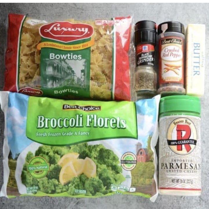 Packages of ingredients: broccoli florets, Parmesan, butter, bow ties, crushed red pepper, and ground black peppercorn