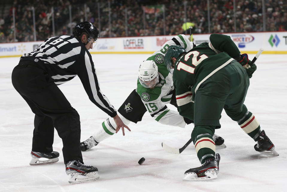 Minnesota Wild's Eric Staal, right, and Dallas Stars' Blake Comeau, center, face off in the second period of an NHL hockey game Saturday, Jan. 18, 2020, in St. Paul, Minn. (AP Photo/Stacy Bengs)