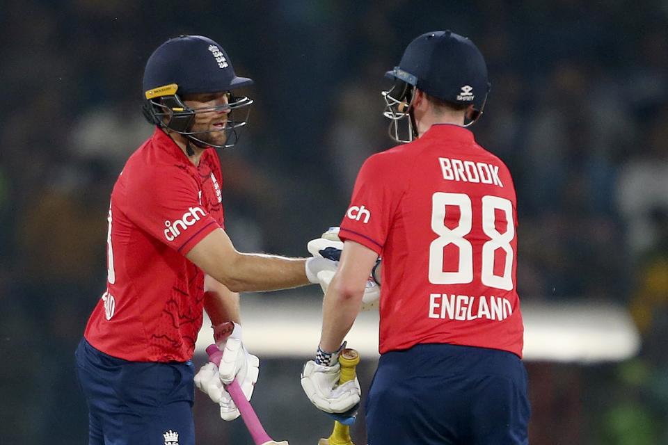 England's Dawid Malan, left, celebrates with teammate Harry Brook after scoring fifty during the seventh twenty20 cricket match between Pakistan and England, in Lahore, Pakistan, Sunday, Oct. 2, 2022. (AP Photo/K.M. Chaudary)