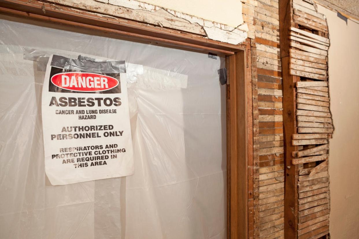 Exposed Wood Wall with Doorway Sealed Off for Asbestos Abatement