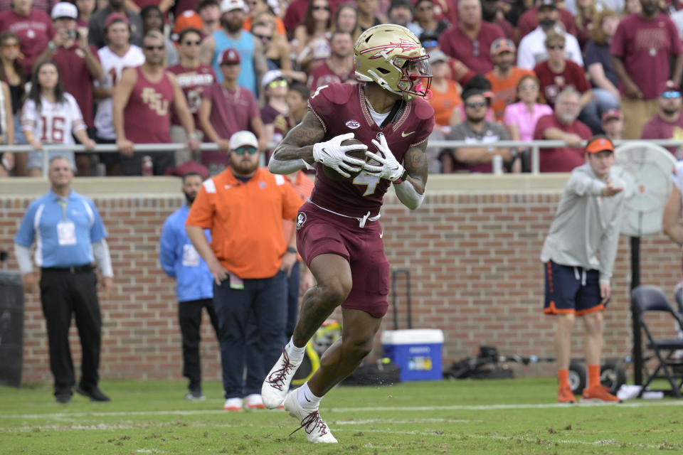 Florida State wide receiver Keon Coleman (4) runs after catching a pass during the first half of an NCAA college football game against Syracuse, Saturday, Oct. 14, 2023, in Tallahassee, Fla. (AP Photo/Phelan M. Ebenhack)