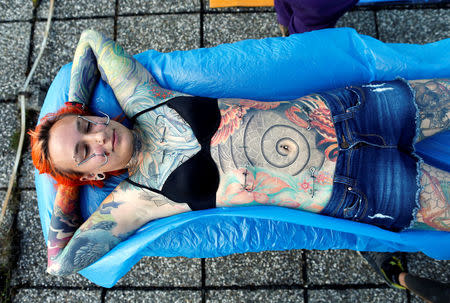 Kaitlin, 28, from the United States waits to be suspended by the professional body artist Dino Helvida in Zagreb, Croatia June 7, 2016. REUTERS/Antonio Bronic