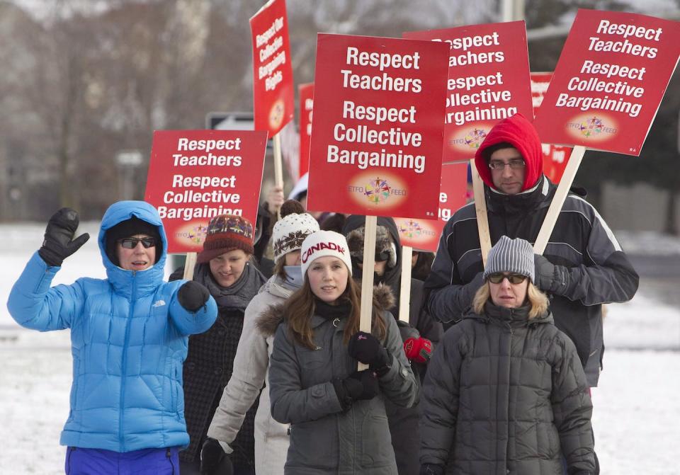 Amid a wave of one-day walkouts, teachers of the Ottawa-Carleton District School Board carry picket signs in protest of Ontario’s Bill 115 a decade ago in Ottawa. The bill was later deemed unconstitutional. THE CANADIAN PRESS/Cole Burston