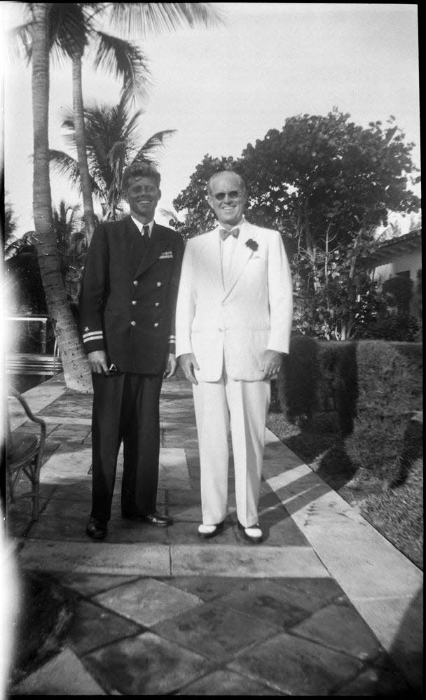 JFK as a Navy lieutenant in the 1940s, posing with his father Joe in Palm Beach.