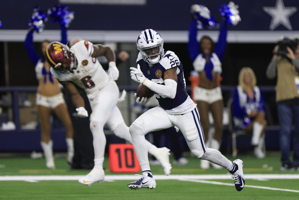 DaRon Bland #26 of the Dallas Cowboys returns an interception for a touchdown while chased by Brian Robinson Jr. #8. (Photo by Ron Jenkins/Getty Images)