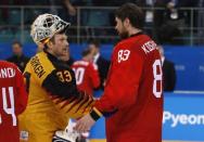 Ice Hockey - Pyeongchang 2018 Winter Olympics - Men Final Match - Olympic Athletes from Russia v Germany - Gangneung Hockey Centre, Gangneung, South Korea - February 25, 2018 - Goalie Vasili Koshechkin, an Olympic athlete from Russia, shakes hands with Germany's goalkeeper Danny Aus Den Birken after winning the final match. REUTERS/Grigory Dukor