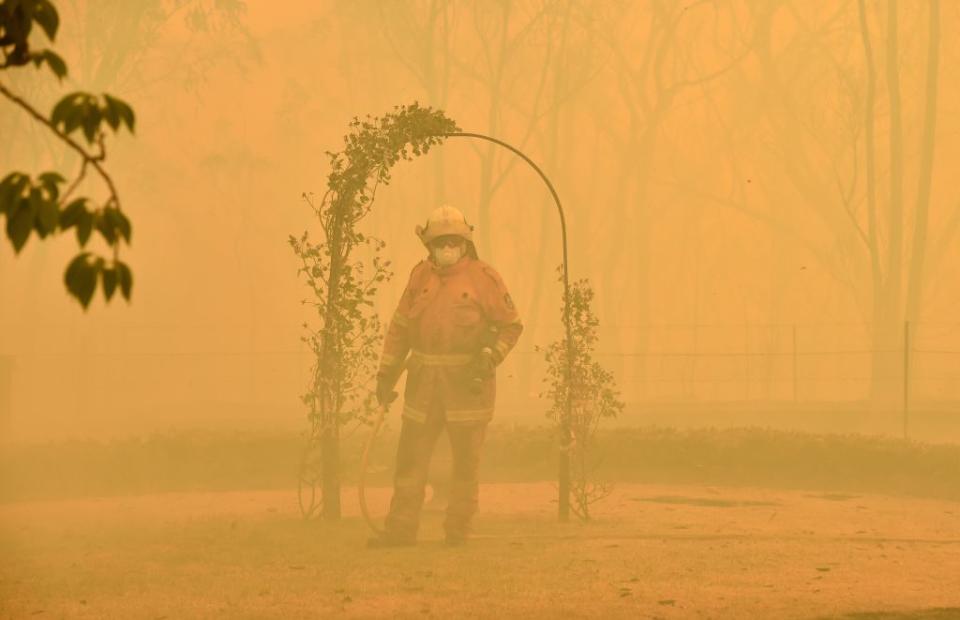 A fireman fights a bushfire to protect a property in Balmoral, 150 kilometres southwest of Sydney.