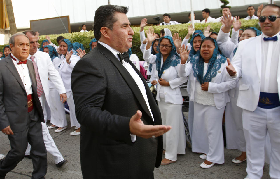 ADDS FIRST NAME - In this Aug. 14, 2018 photo, Naasón Joaquín García greets members of his church "La Luz del Mundo" in Guadalajara, Mexico. Garcia, the leader and self-proclaimed apostle of the controversial church that claims over 1 million followers, has been charged with human trafficking and child rape, California authorities said on Tuesday, June 4, 2019. (AP Photo)