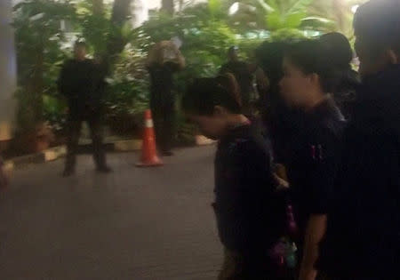 Indonesian Siti Aisyah, who is accused of killing Kim Jong Nam, the estranged half-brother of North Korea's leader, is escorted by police as she arrives at at the Shah Alam High Court on the outskirts of Kuala Lumpur, Malaysia, in this still image taken from a TV footage, October 2, 2017. REUTERS/via Reuters TV