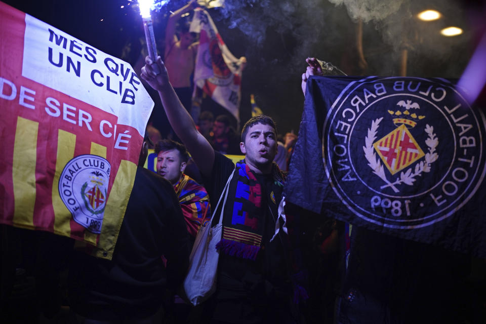 Barcelona fans celebrate in the street after their team won the Spanish La Liga championship by beating crosstown rivals Espanyol in Barcelona, Spain, Sunday May 14, 2023. (AP Photo/Joan Mateu Parra)