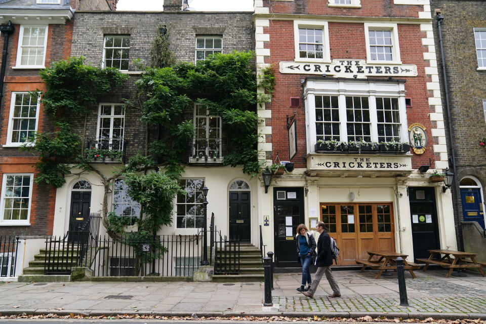 People walk past a public house in Richmond-upon-Thames, west London, as more than half of England is living with heightened coronavirus restrictions after the severest measures came into force in Lancashire and Londoners were banned from meeting indoors. (Photo by John Walton/PA Images via Getty Images)