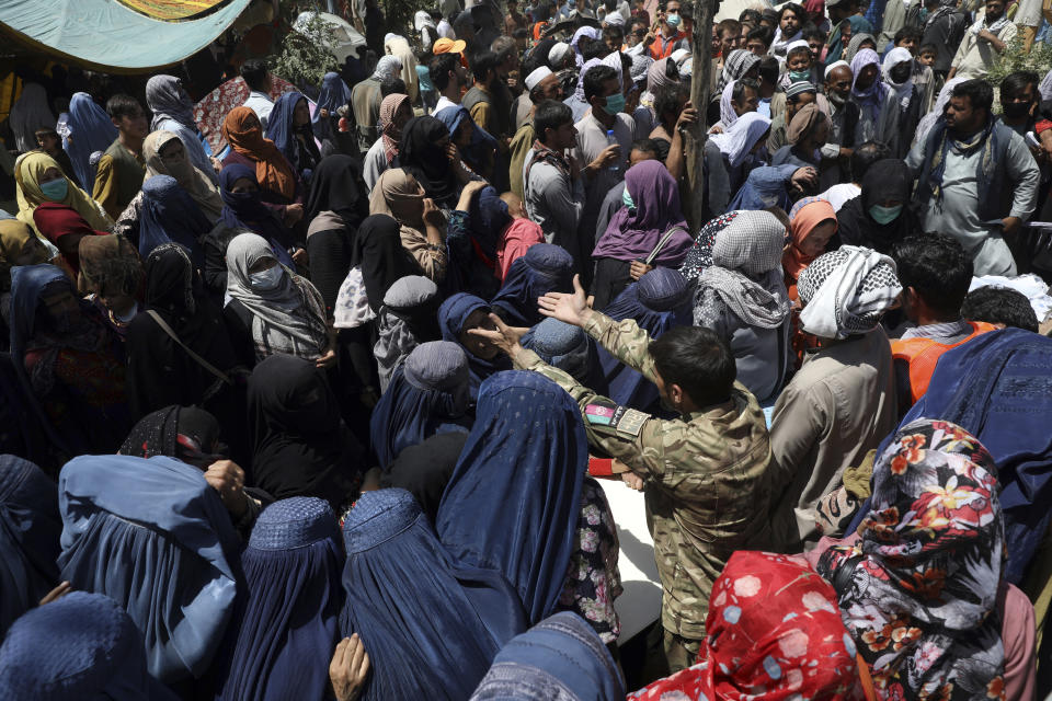 Internally displaced Afghans from northern provinces, who fled their home due to fighting between the Taliban and Afghan security personnel, wait to receive free food in a public park in Kabul, Afghanistan, Tuesday, Aug. 10, 2021. (AP Photo/Rahmat Gul)