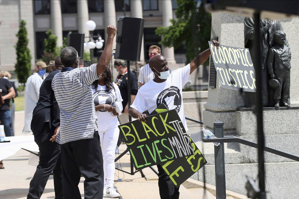 People demonstrate at the Minnesota State Capitol in St. Paul, Minn. on Friday, June 19, 2020, to mark Juneteenth. Juneteenth marks the day in 1865 when federal troops arrived in Galveston, Texas, to take control of the state and ensure all enslaved people be freed, more than two years after the Emancipation Proclamation. (AP Photo/Jim Mone)