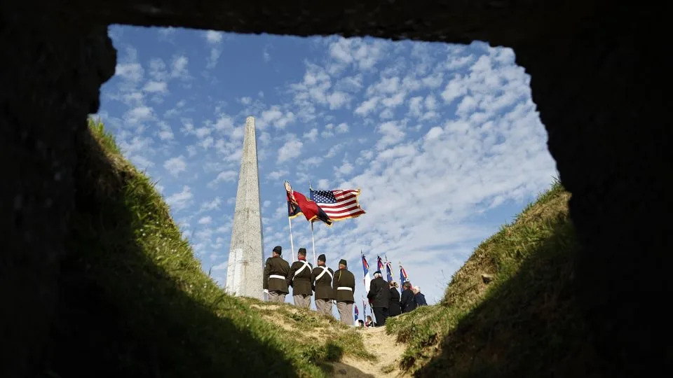 US soldiers attend a wreath-laying ceremony Tuesday at the 1st Infantry Division monument near Omaha Beach. - Jeremias Gonzalez/AP