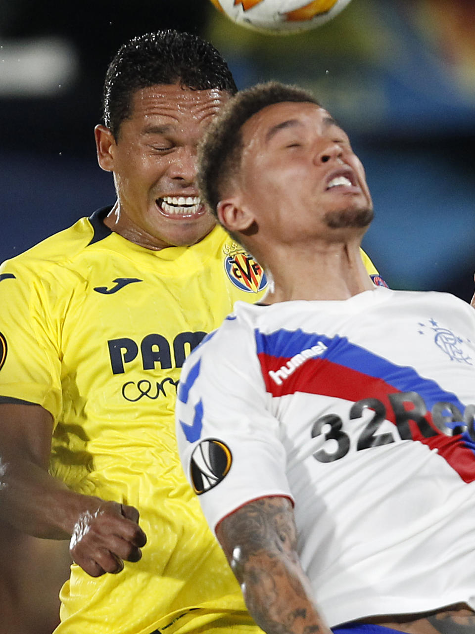 Villarreal's Carlos Bacca, left, jumps for the ball above Rangers' James Tavernier during the Europa League soccer match between Villarreal and Rangers at the Ceramica stadium in Villarreal, Spain, Thursday, Sept. 20, 2018. (AP Photo/Alberto Saiz)