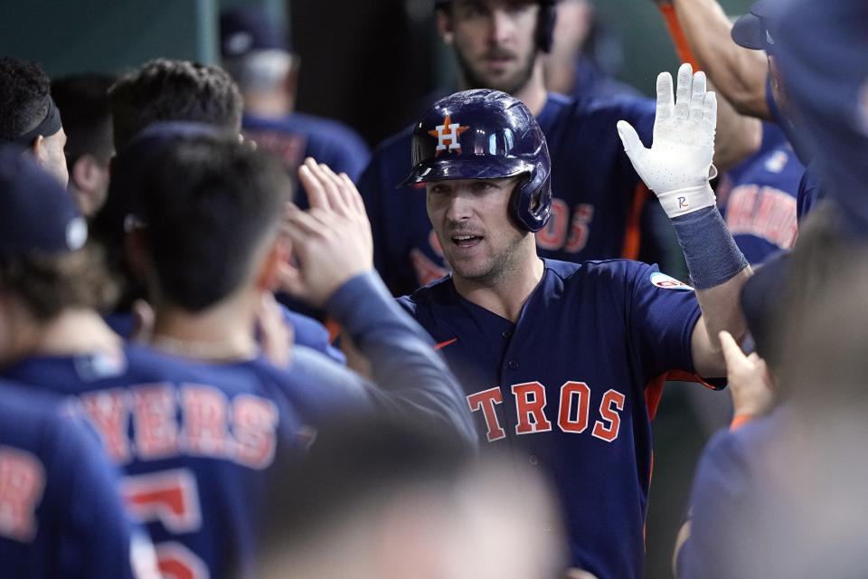 Houston Astros' Alex Bregman celebrates in the dugout after hitting a two-run home run against the San Francisco Giants during the eighth inning of a baseball game Wednesday, May 3, 2023, in Houston. (AP Photo/David J. Phillip)