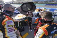 Noah Gragson, center, talks with his crew before the start of a NASCAR Xfinity Series auto race, Saturday, Feb. 27, 2021, in Homestead, Fla. (AP Photo/Wilfredo Lee)