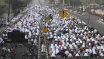 Muslim perform Eid al-Fitr prayer marking the end of the holy fasting month of Ramadan on a street in in Bekasi , West Java, Indonesia, Thursday, May 13, 2021. (AP Photo/Achmad Ibrahim)