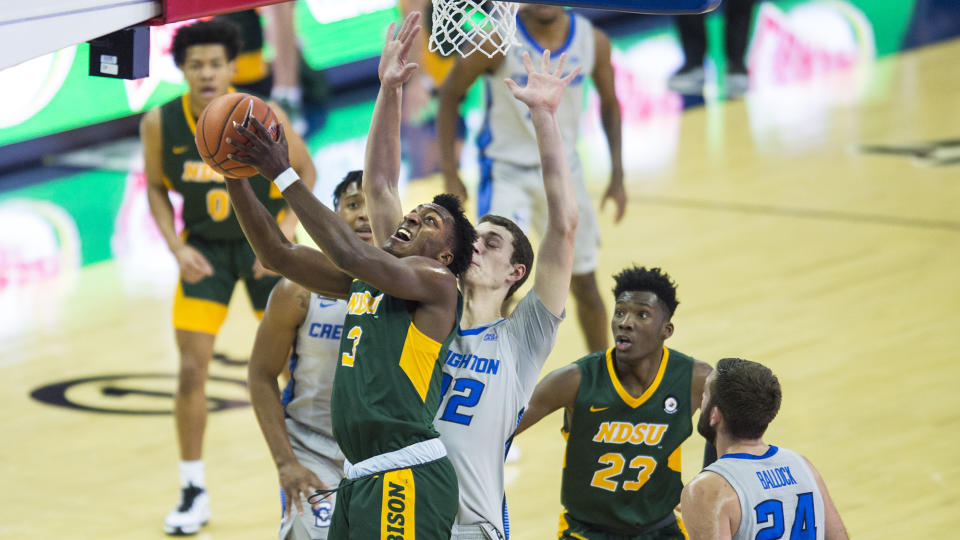 North Dakota State's Tyree Eady, left, rebounds against Creighton's Ryan Kalkbrenner, center, during the first half of an NCAA college basketball game in Omaha, Neb., Sunday, Nov. 29, 2020. (AP Photo/Kayla Wolf)