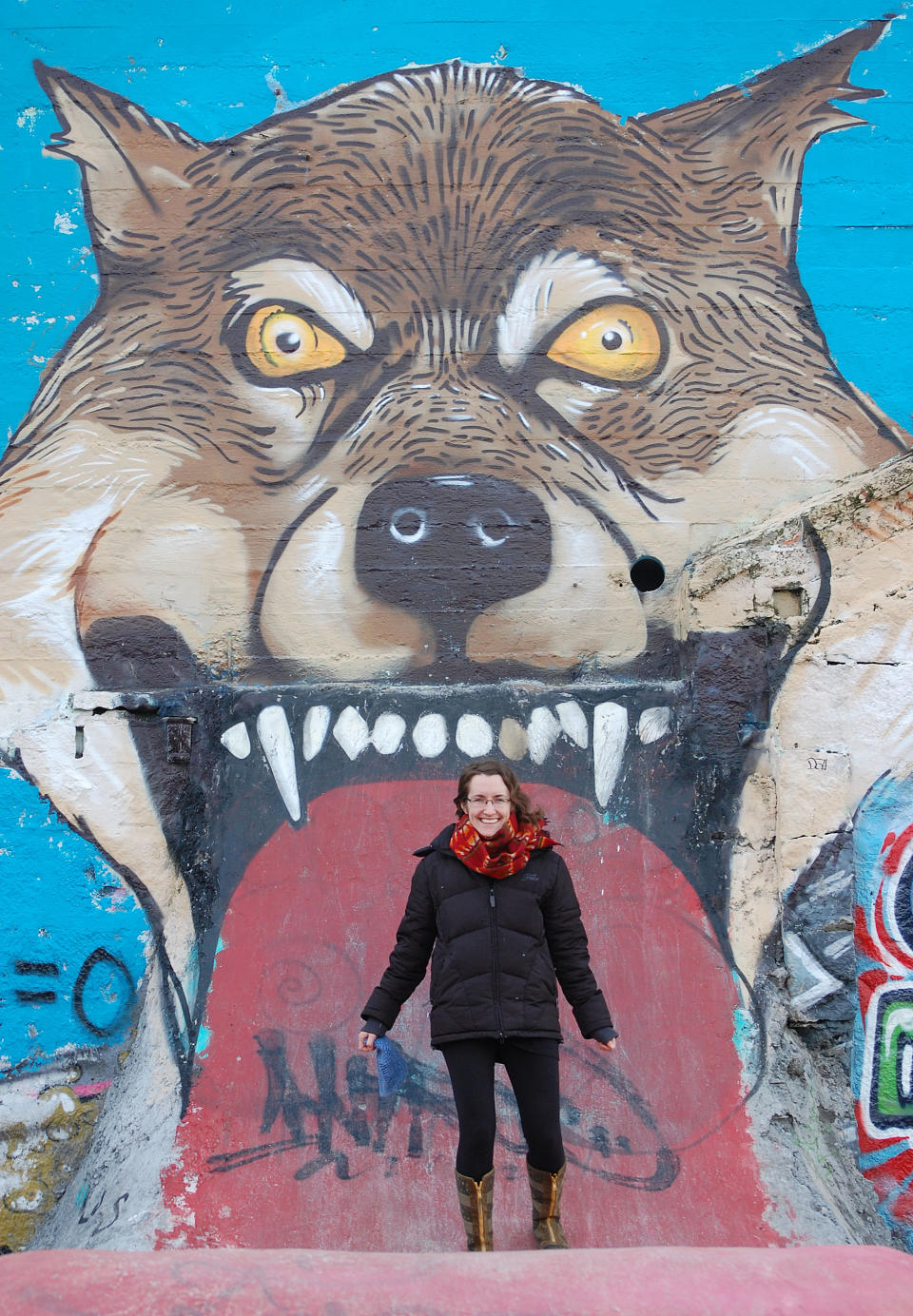 In this March 2013 photo provided by Jaimes Valdez, Rachael Pecore-Valdez stands in front of a mural at a skate park in Reykjavik, Iceland. An expedition is gearing up to hike and bike the 1,200-mile trail of wandering wolf OR-7 as he trekked across Oregon into Northern California, looking for a mate in territory that hasn’t seen his like in nearly a century. The expedition is the brainchild of Portland storyteller Pecore-Valdez. She was in Berlin, where her husband was studying renewable energy, when she talked to a South African friend about a trek he had done to raise awareness for endangered rhinos. She decided to do something similar for OR-7. (AP Photo/Jaimes Valdez)